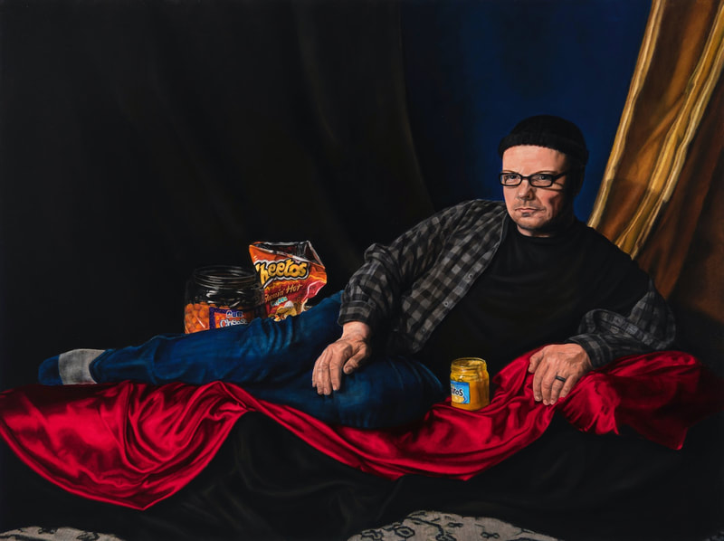 Bro con Queso shows a recumbent man propped up on his left elbow as he lies upon red satin fabric in a dark room. He is wearing a plaid shirt with blue jeans, and he poses with processed cheese flavored snacks. 